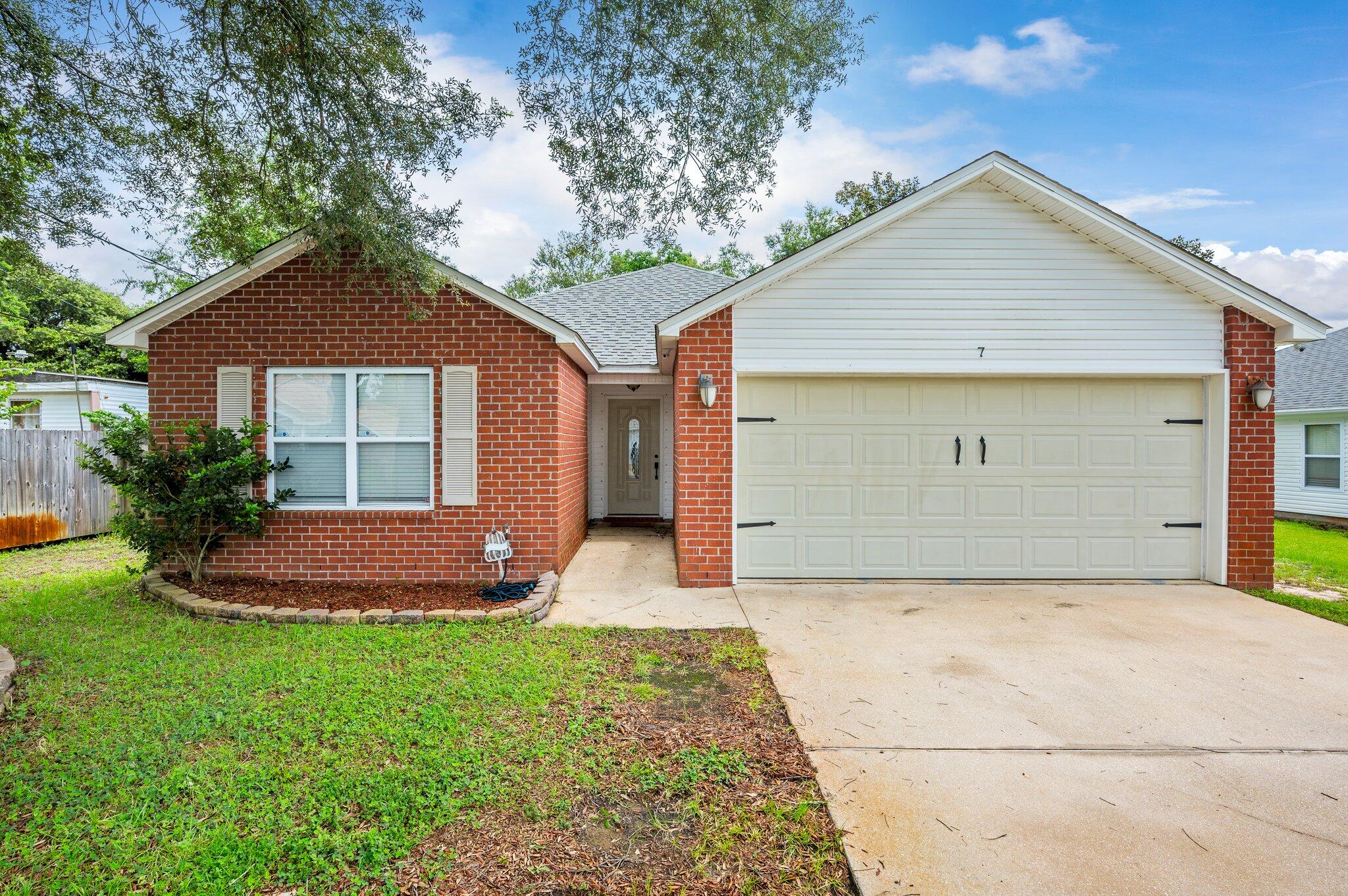 7 Snook Road Mary Esther, FL 32569 - Photo 1 of 38 a front view of house with yard and green space