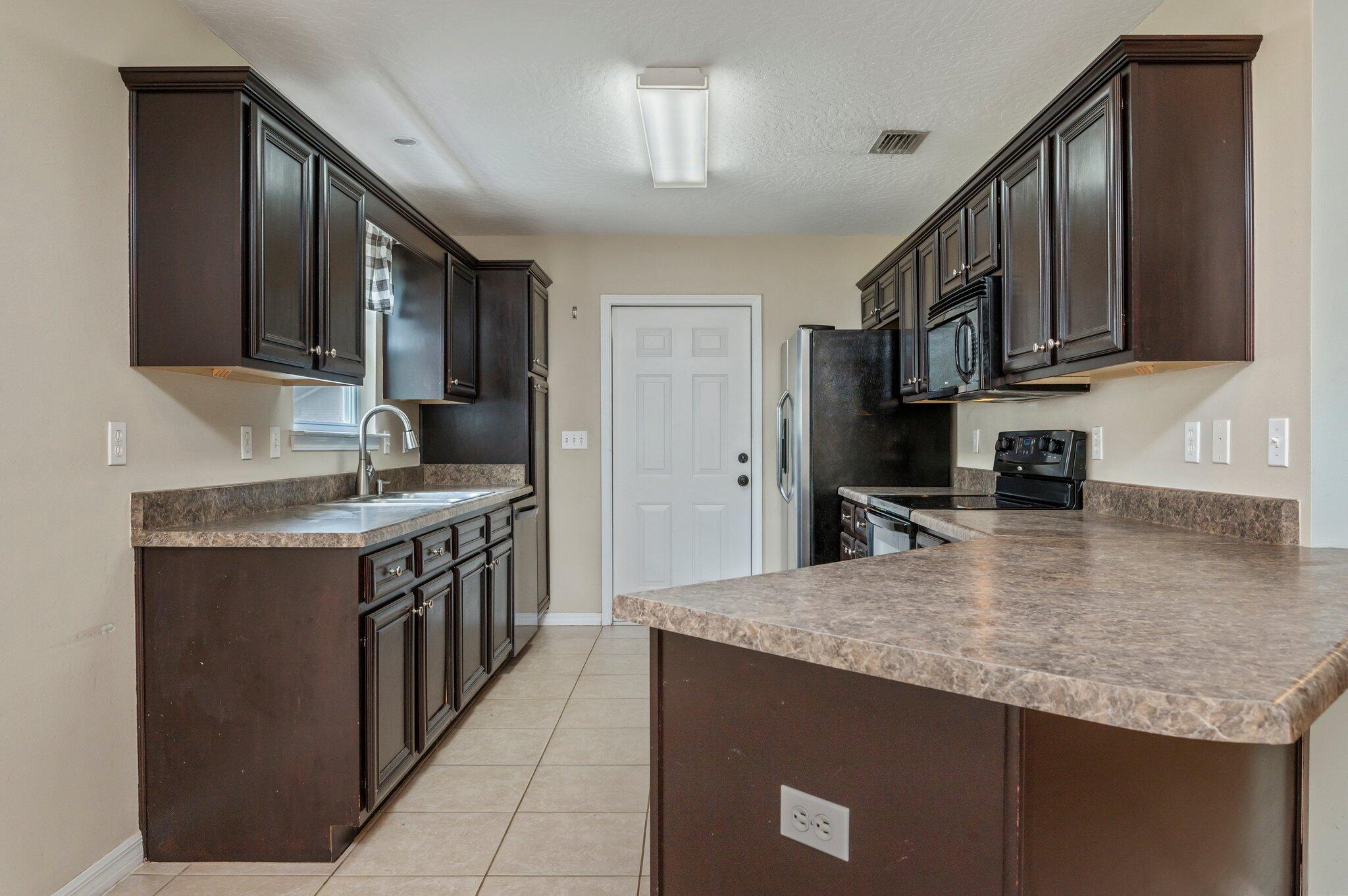 7 Snook Road Mary Esther, FL 32569 - Photo 18 of 38 a kitchen with stainless steel appliances granite countertop a sink stove and refrigerator