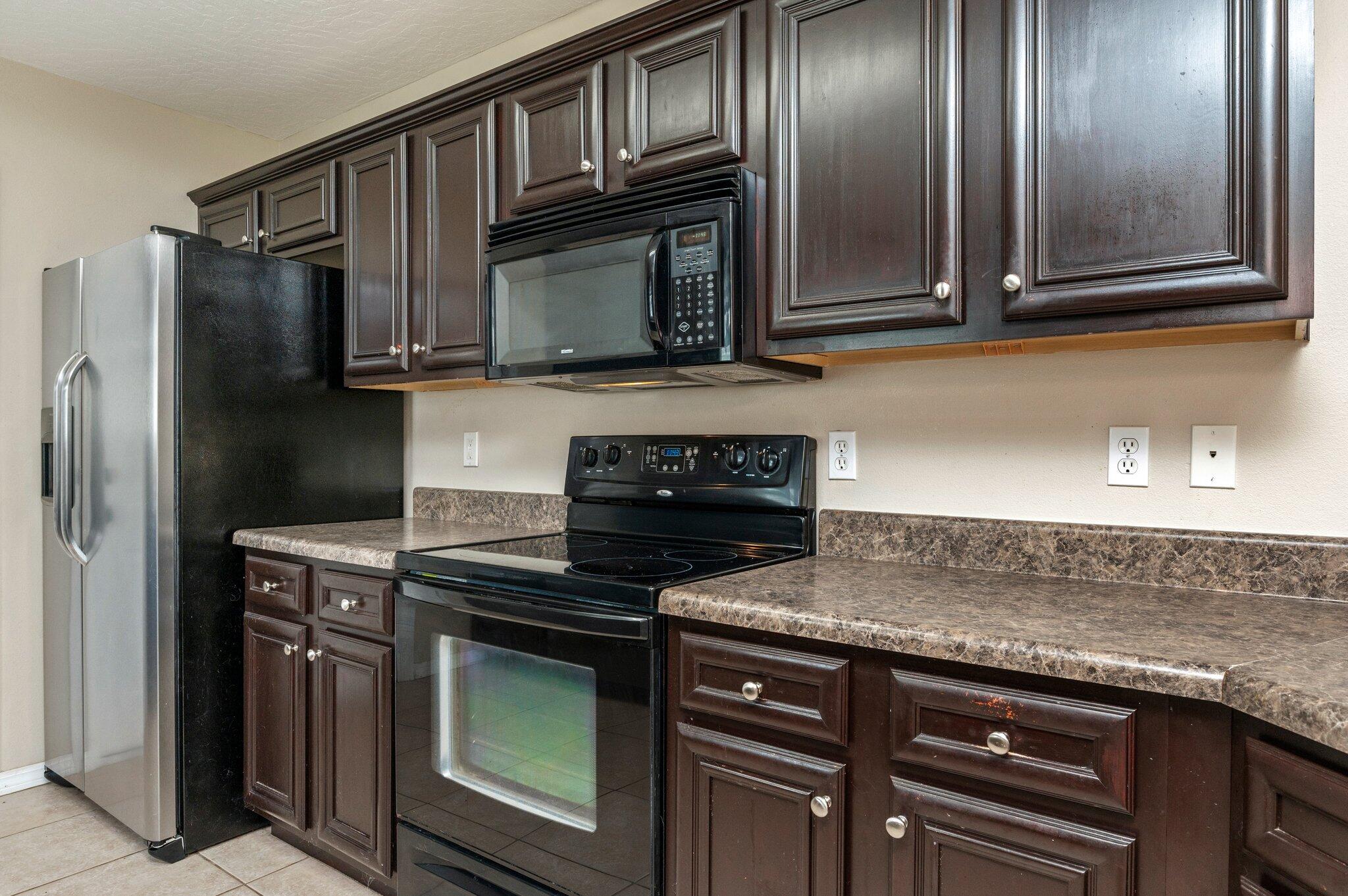 7 Snook Road Mary Esther, FL 32569 - Photo 20 of 38 a kitchen with stainless steel appliances granite countertop a stove microwave and refrigerator