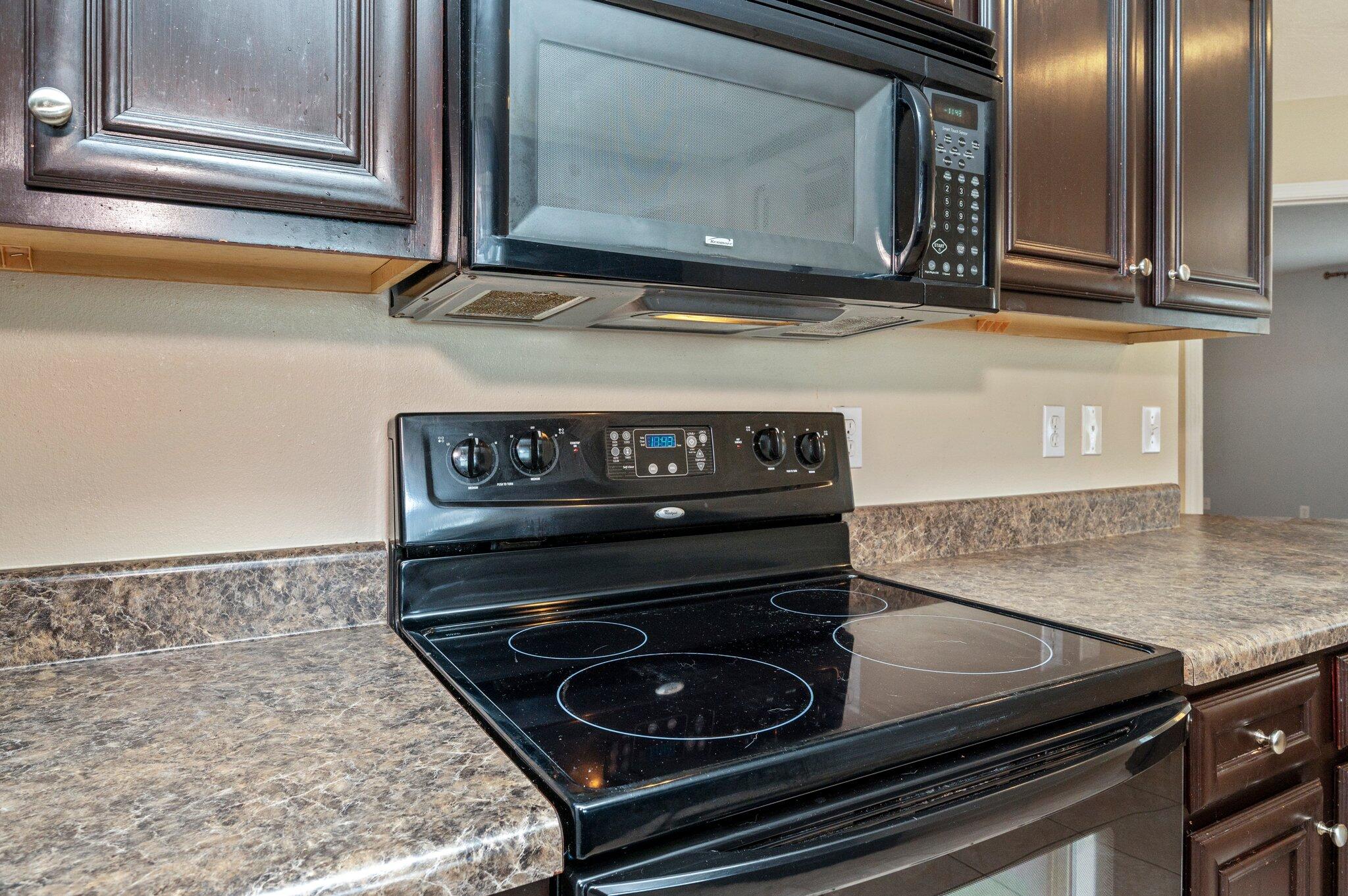 7 Snook Road Mary Esther, FL 32569 - Photo 22 of 38 a kitchen with granite countertop a stove and a microwave