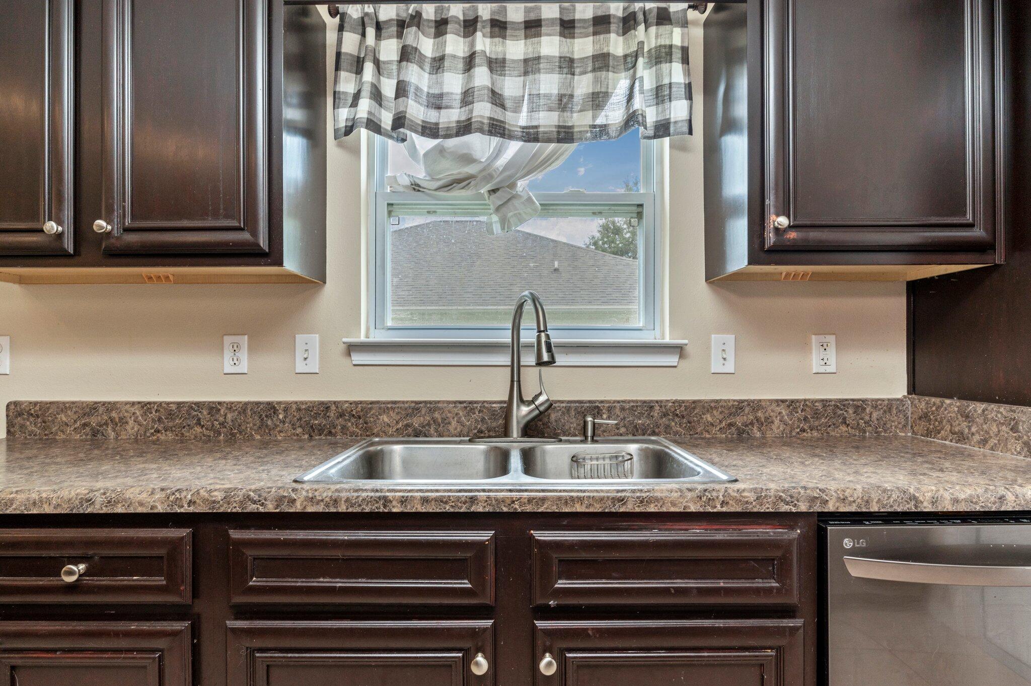 7 Snook Road Mary Esther, FL 32569 - Photo 23 of 38 a kitchen with a sink and cabinets