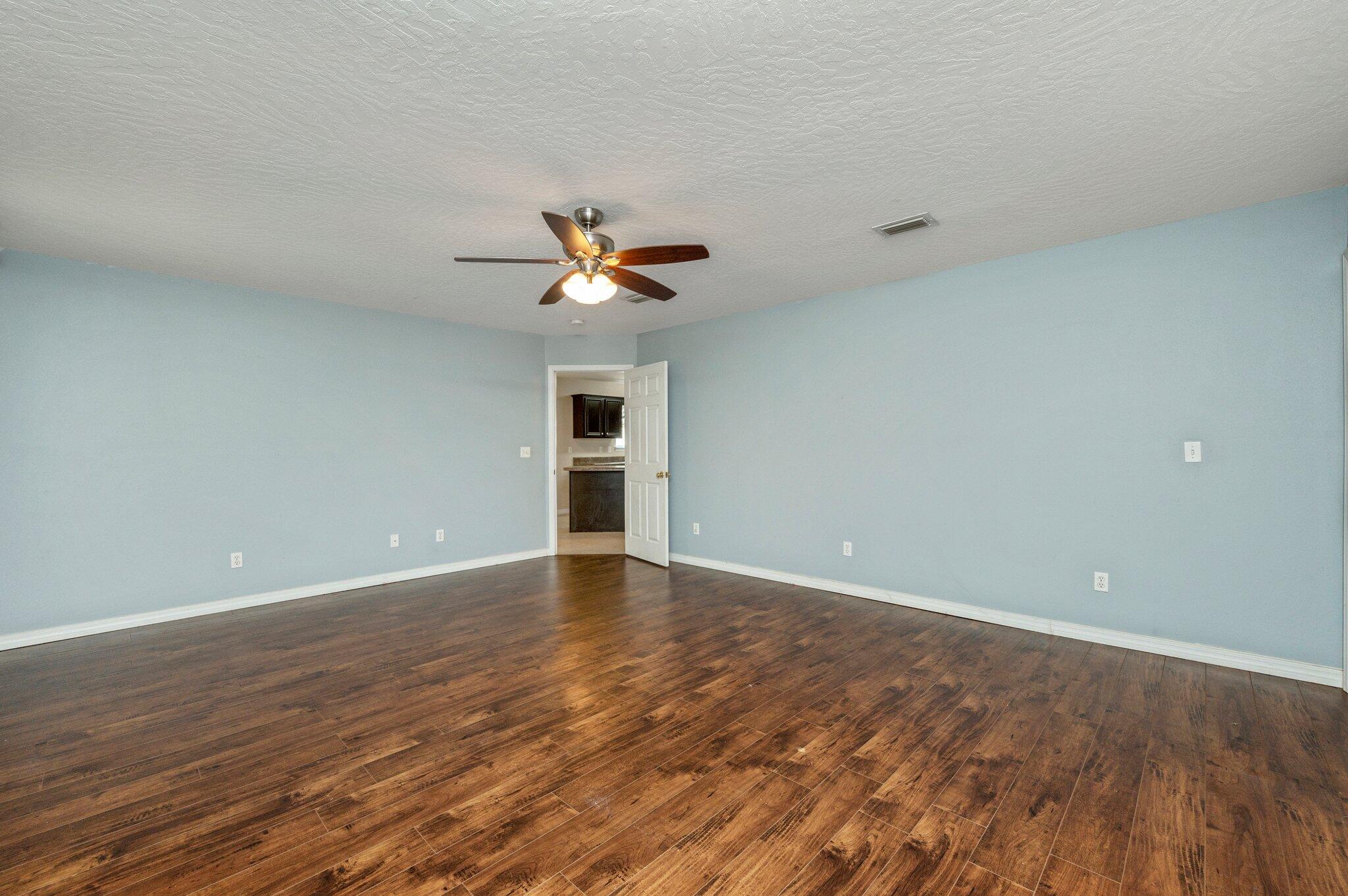 7 Snook Road Mary Esther, FL 32569 - Photo 26 of 38 a view of an empty room with a chandelier fan and a window