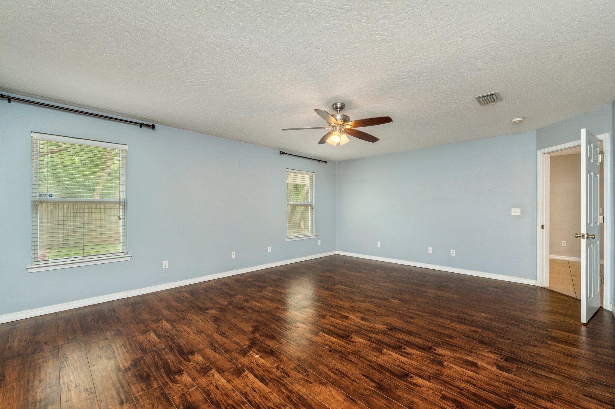 7 Snook Road Mary Esther, FL 32569 - Photo 27 of 38 a view of an empty room with wooden floor and a window