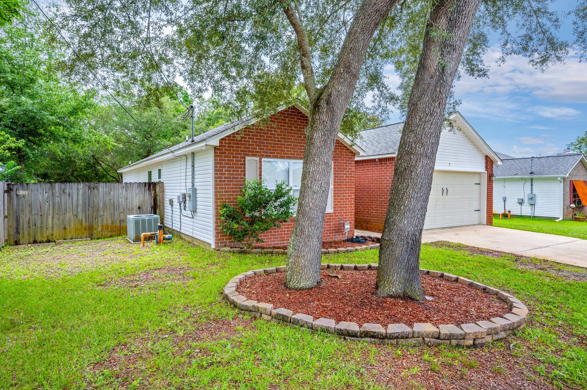 7 Snook Road Mary Esther, FL 32569 - Photo 3 of 38 a backyard of a house with table and chairs