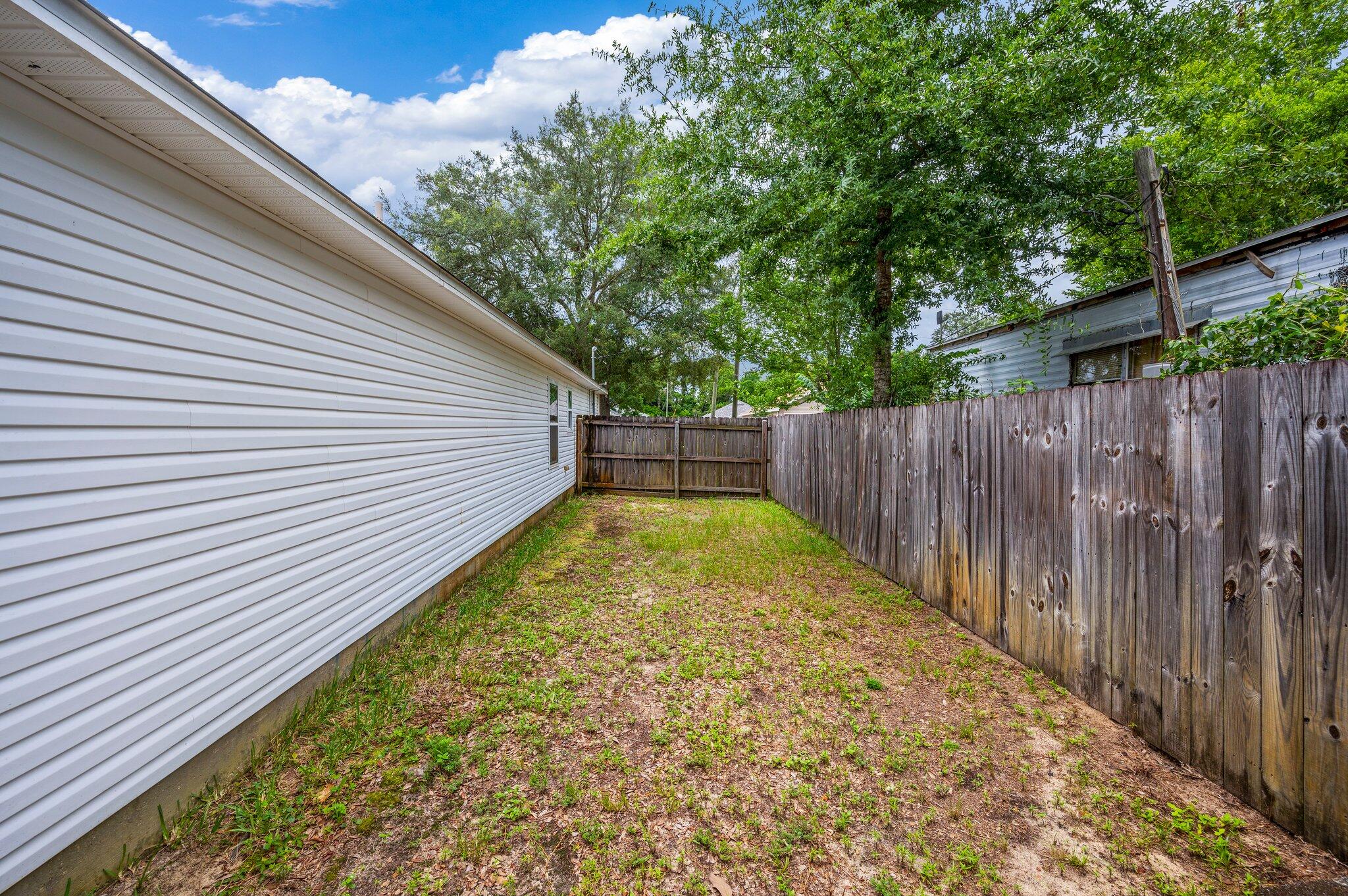7 Snook Road Mary Esther, FL 32569 - Photo 33 of 38 a view of a backyard with wooden fence
