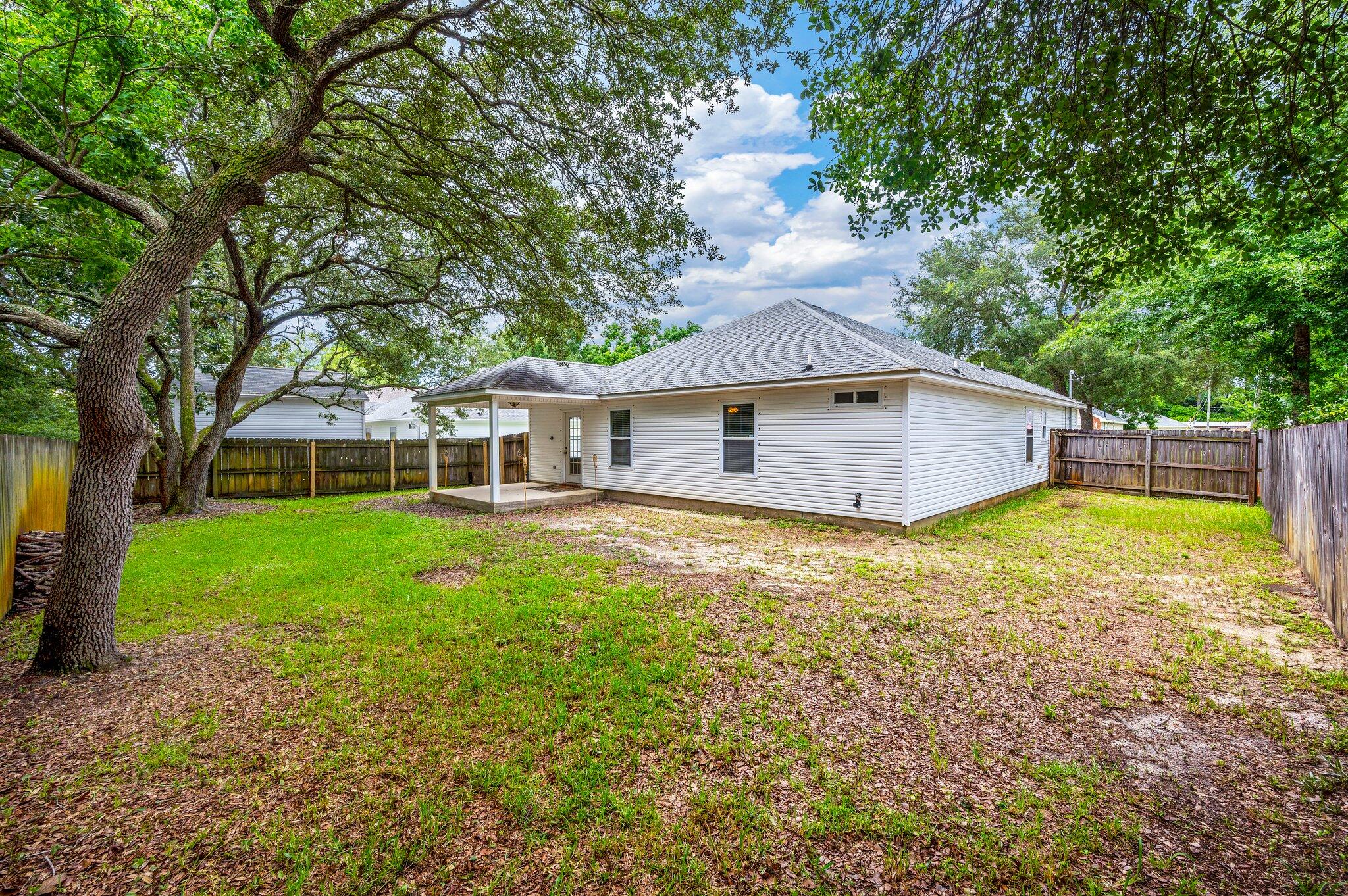 7 Snook Road Mary Esther, FL 32569 - Photo 35 of 38 a front view of a house with a garden