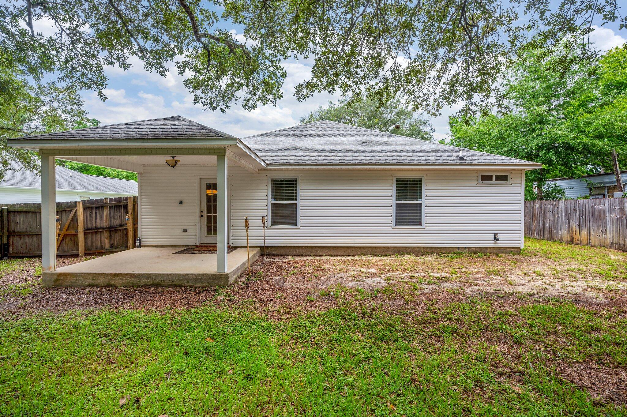 7 Snook Road Mary Esther, FL 32569 - Photo 36 of 38 a house with trees in front of it