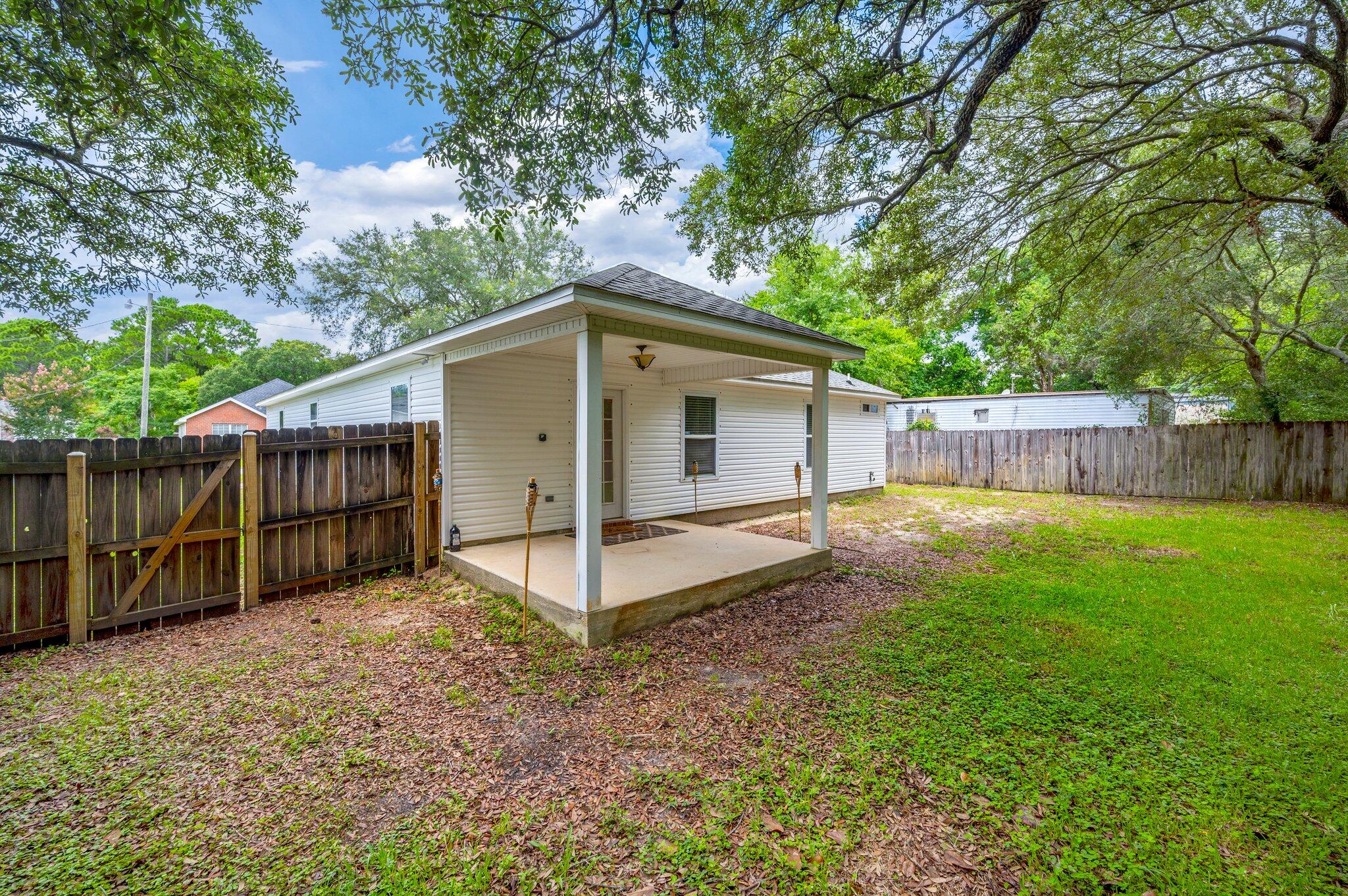 7 Snook Road Mary Esther, FL 32569 - Photo 37 of 38 a view of a house with a yard and wooden fence