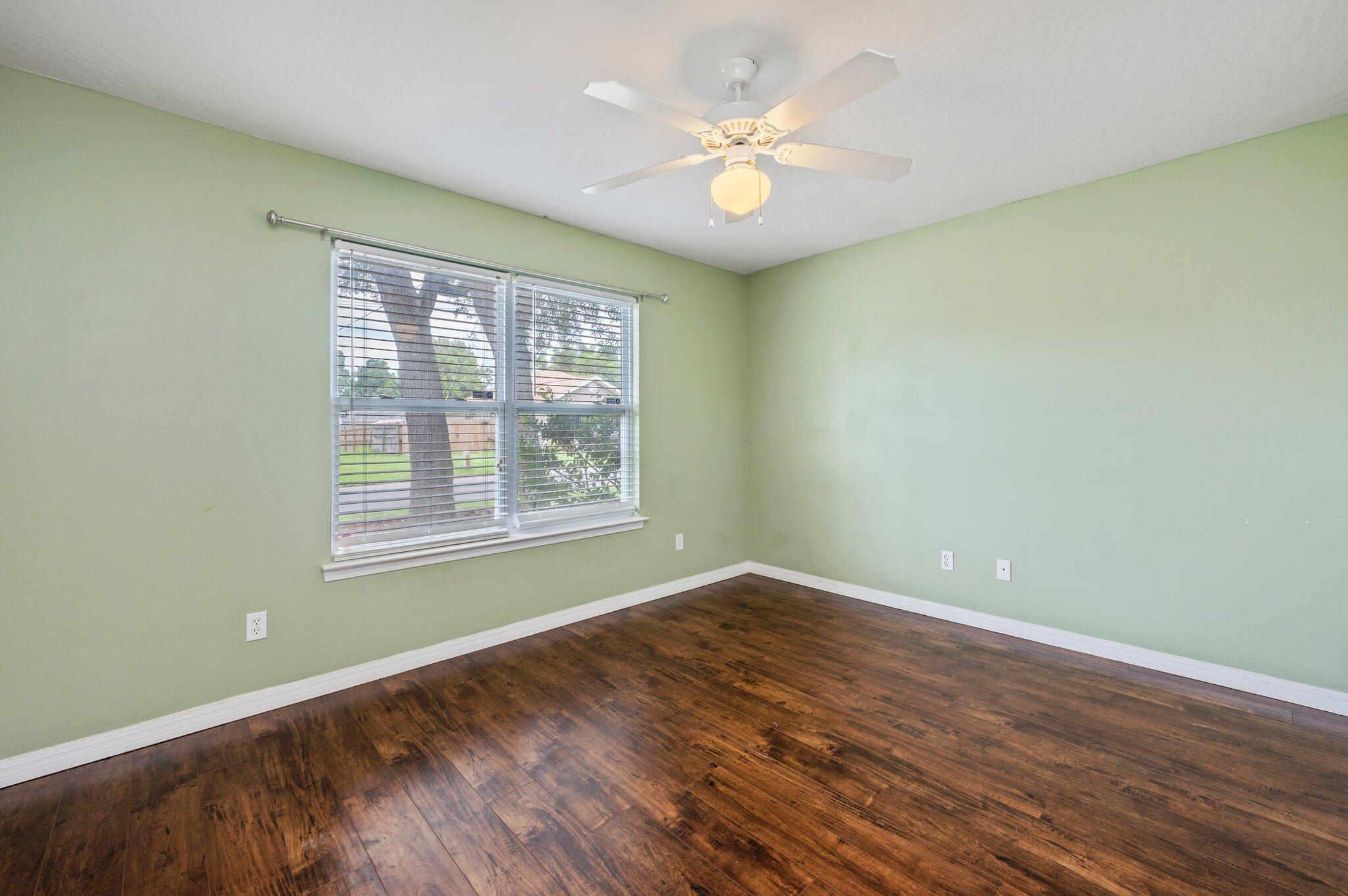 7 Snook Road Mary Esther, FL 32569 - Photo 6 of 38 an empty room with wooden floor and windows