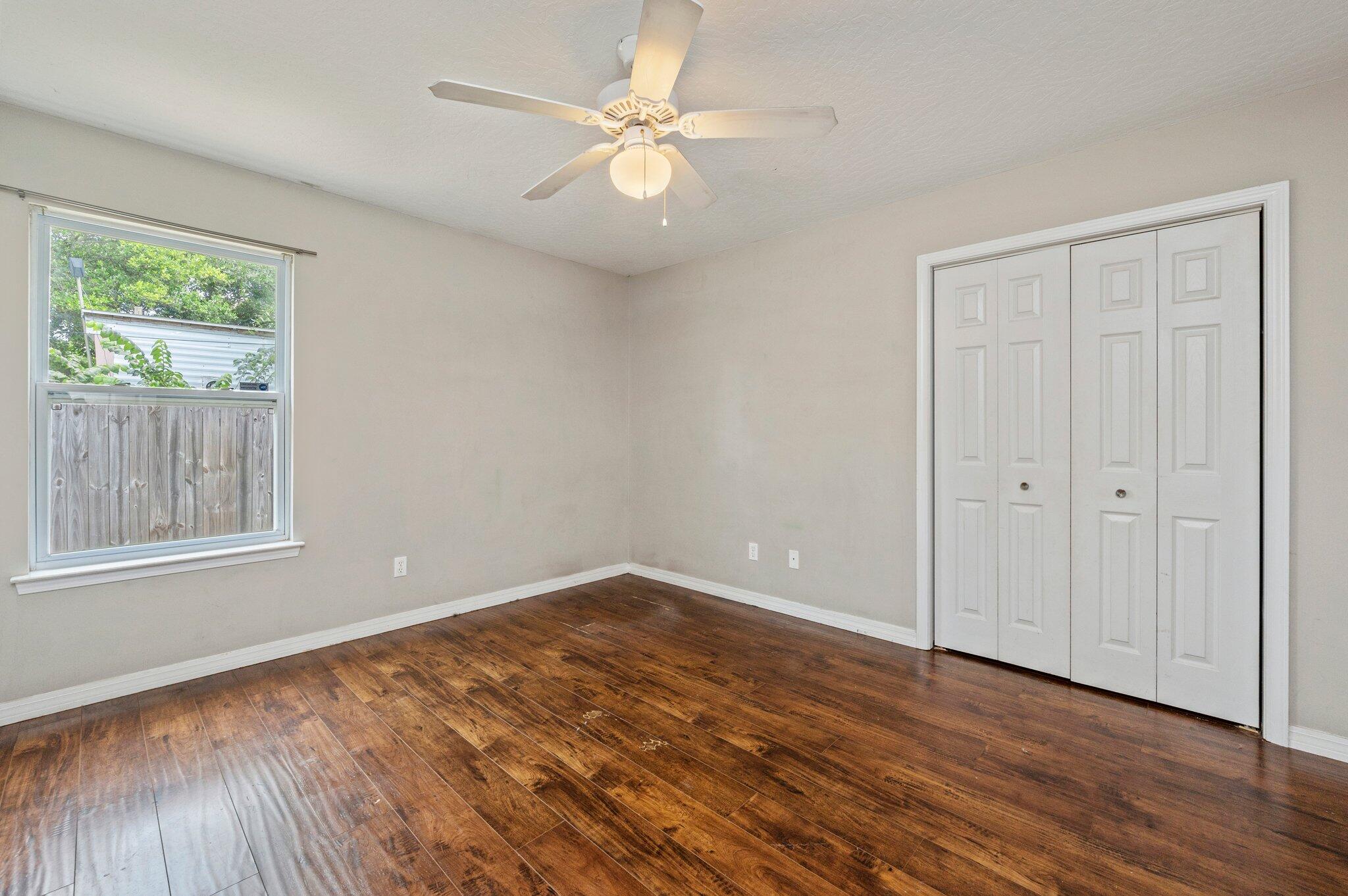7 Snook Road Mary Esther, FL 32569 - Photo 8 of 38 a view of an empty room with wooden floor and a window