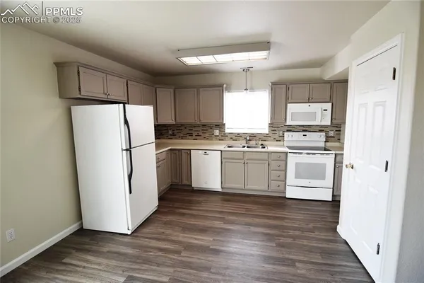 a view of a room with wooden floor and staircase