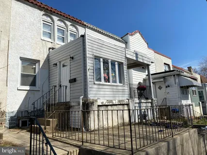 a view of a house with wooden fence