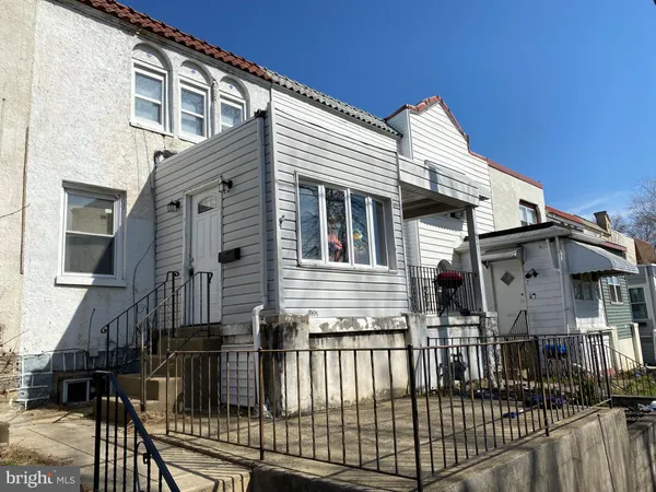 a view of a house with wooden fence