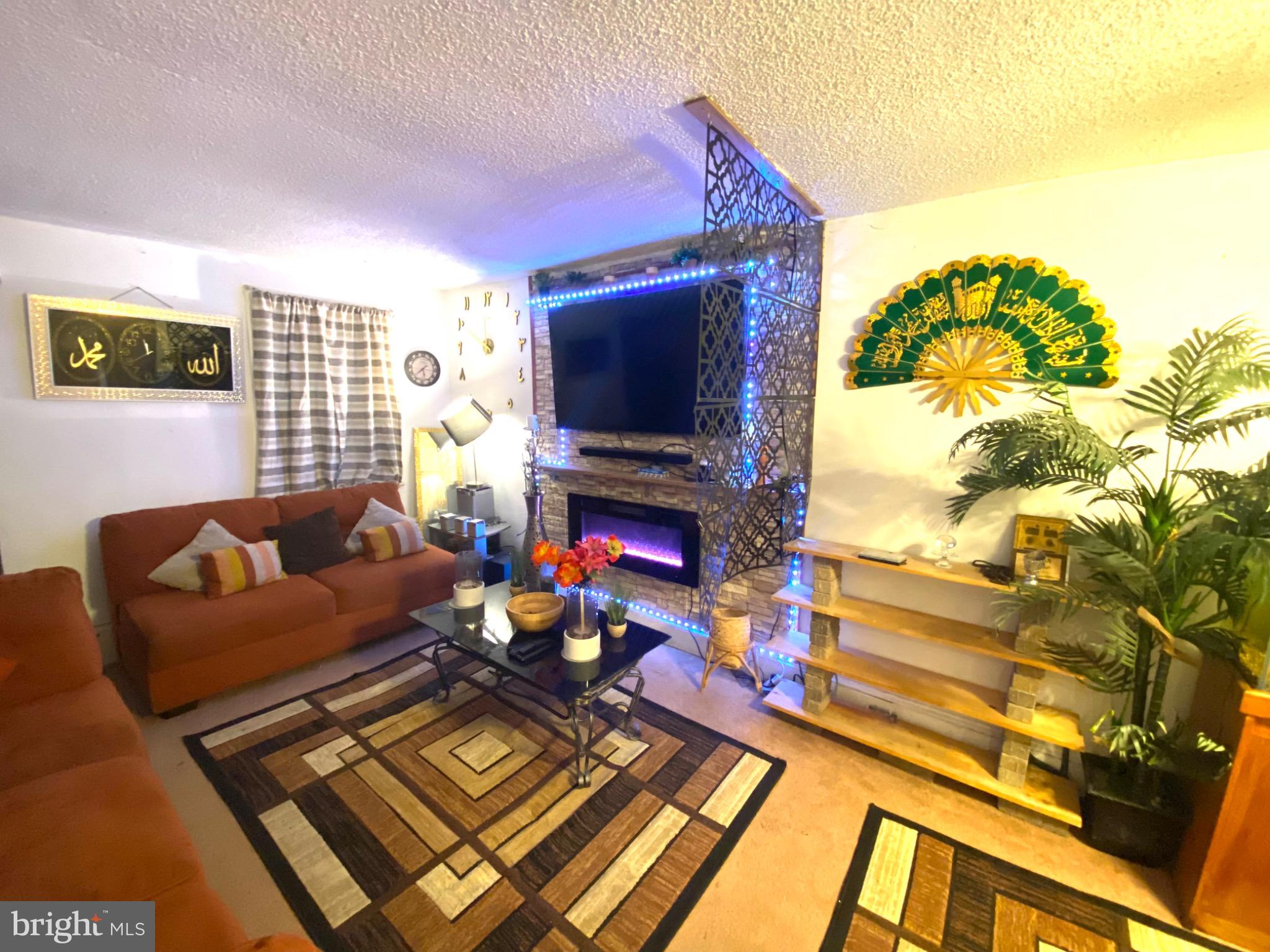 6993 Guilford Road Upper Darby, PA 19082 - Photo 6 of 21 Cozy living space with vibrant decor accents.