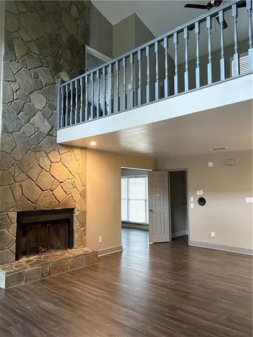 a view of livingroom with wooden floor and a fireplace