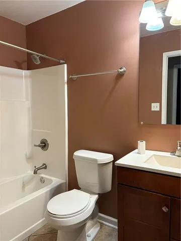 a bathroom with a toilet a sink and bathtub