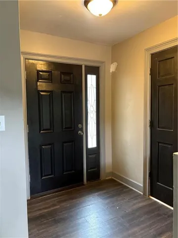 an empty room with wooden floor and closet