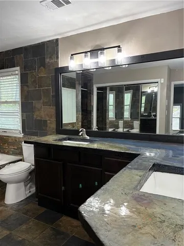 a bathroom with a sink and a large mirror