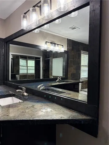 a bathroom with a sink and a mirror