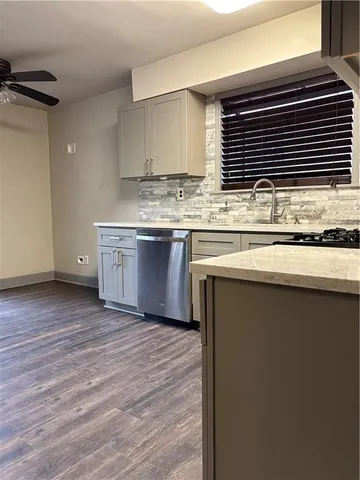 a kitchen with granite countertop a sink and a stove top oven