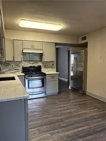 a kitchen with stainless steel appliances a stove and a refrigerator