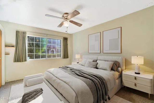 a bedroom with a large bed and a window