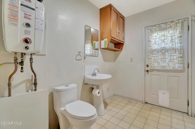 a white toilet sitting next to a bathroom sink