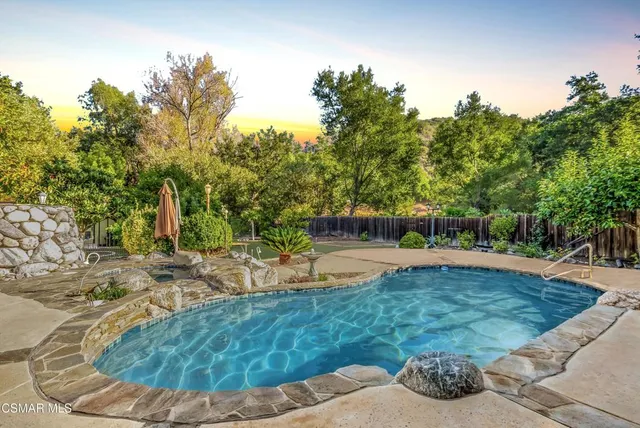 a view of a swimming pool with a sitting area