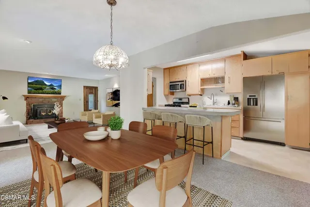 a view of a dining room with furniture a chandelier and wooden floor