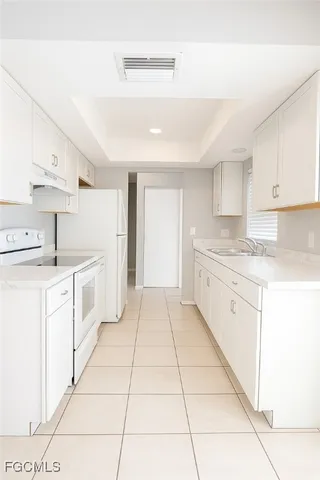 a kitchen with cabinets and white appliances