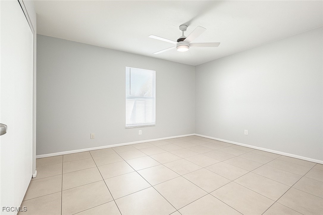 4532 Southwest 8th Place, Unit A Cape Coral, FL 33914 - Photo 8 of 14 an empty room with windows and fan