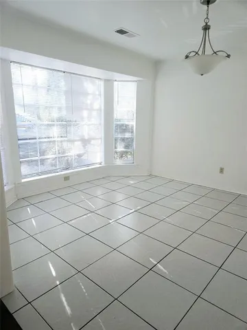 a view of an empty room and a window