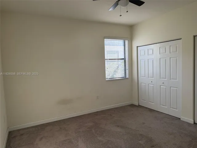 an empty room with windows and closet