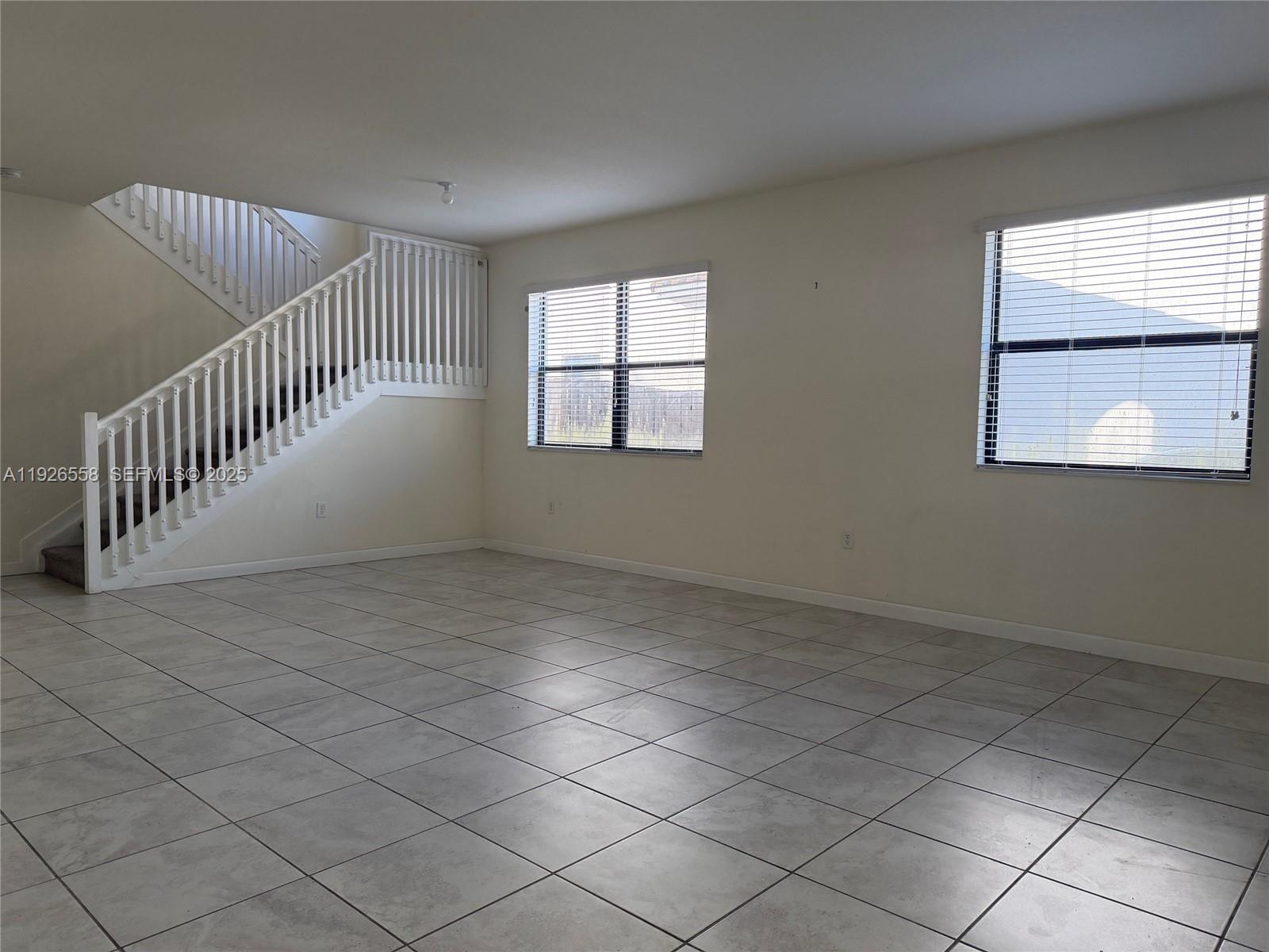 24886 Southwest 118th Avenue, Unit 24886 Homestead, FL 33032 - Photo 7 of 7 an empty room with windows