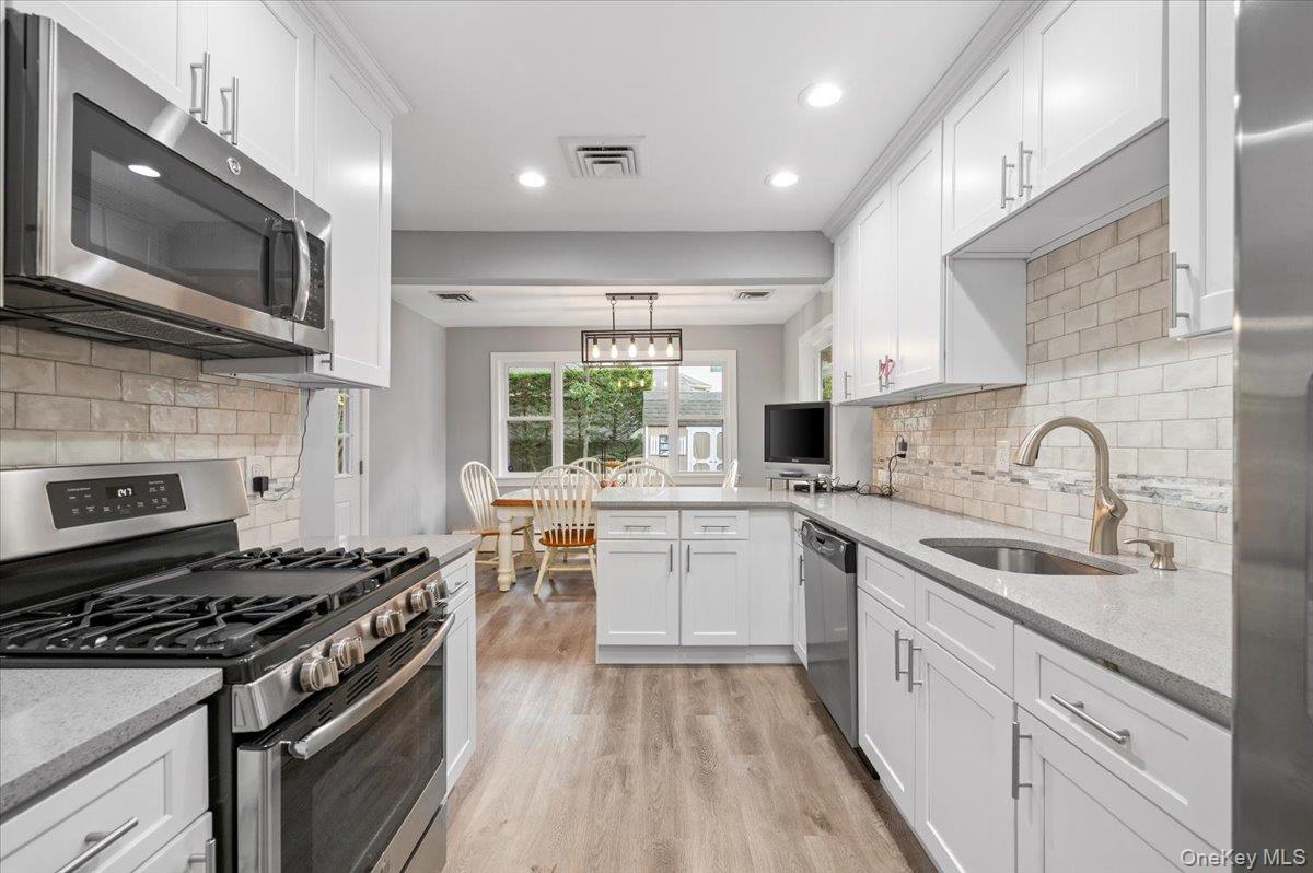 1109 Round Swamp Road Old Bethpage, NY 11804 - Photo 12 of 50 a kitchen with a sink stove top oven and refrigerator