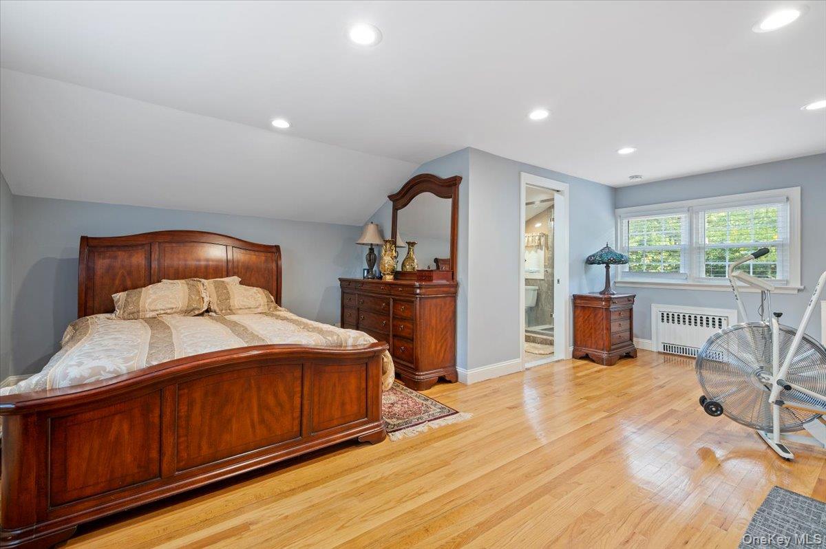 1109 Round Swamp Road Old Bethpage, NY 11804 - Photo 18 of 50 a bedroom with a bed and large windows