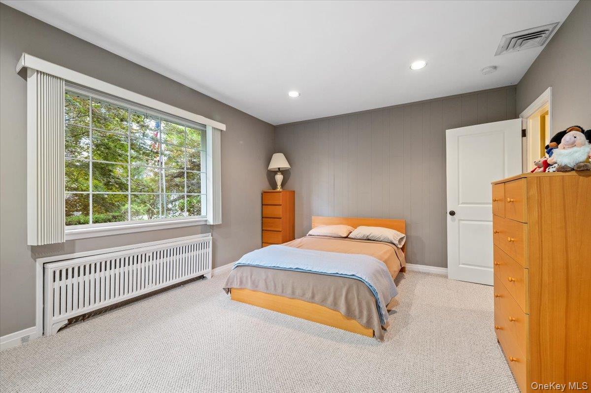 1109 Round Swamp Road Old Bethpage, NY 11804 - Photo 23 of 50 a bedroom with a bed and a window