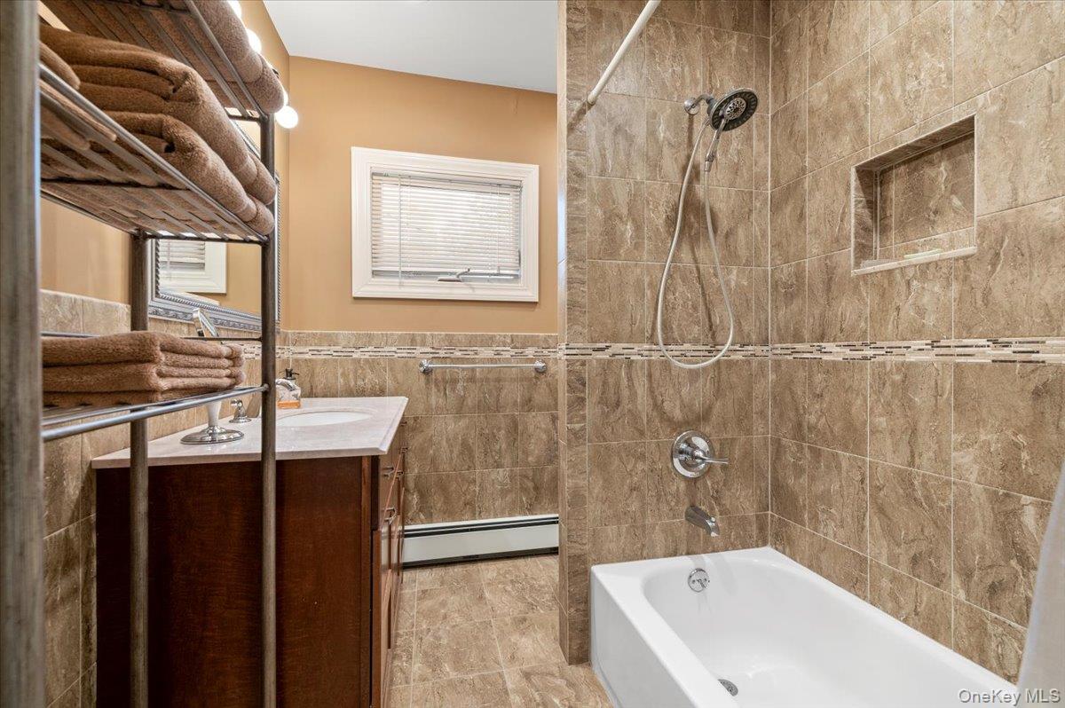 1109 Round Swamp Road Old Bethpage, NY 11804 - Photo 25 of 50 a bathroom with a sink and a bathtub