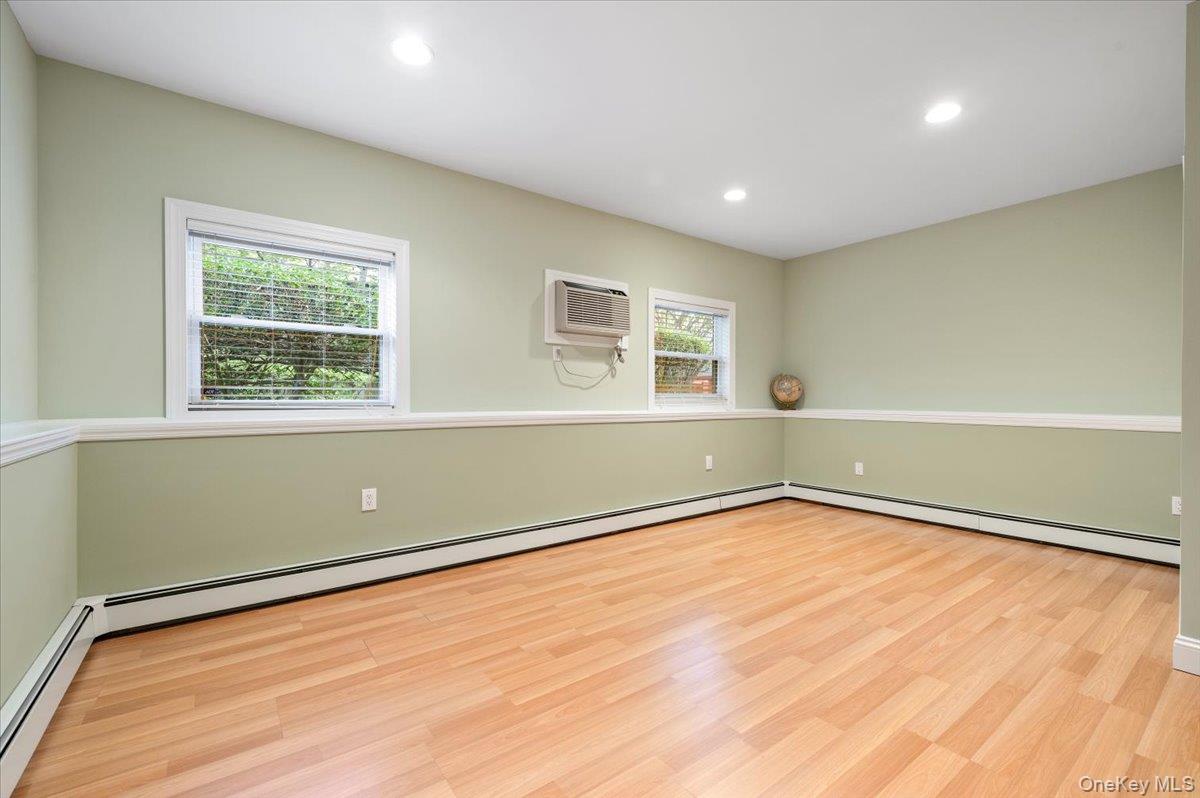 1109 Round Swamp Road Old Bethpage, NY 11804 - Photo 31 of 50 a view of an empty room with wooden floor and a window