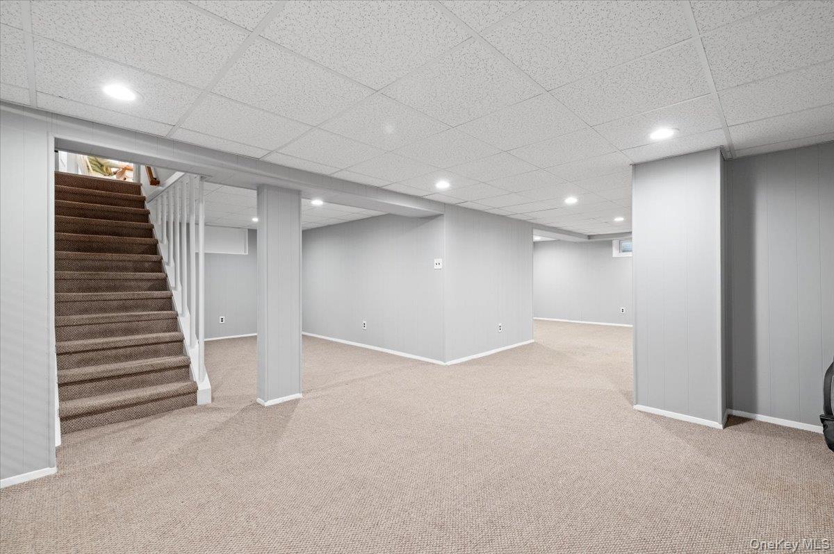 1109 Round Swamp Road Old Bethpage, NY 11804 - Photo 36 of 50 an empty room with a hallway and stairs