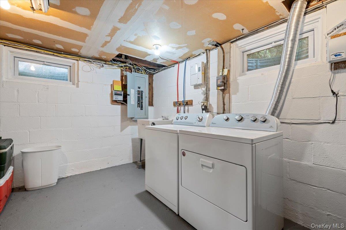 1109 Round Swamp Road Old Bethpage, NY 11804 - Photo 39 of 50 a bathroom with a sink a toilet and mirror