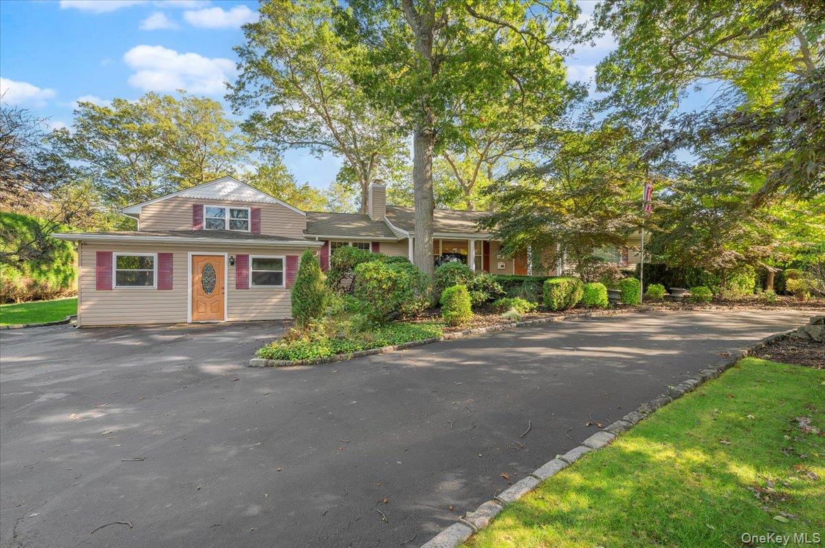 1109 Round Swamp Road Old Bethpage, NY 11804 - Photo 4 of 50 a front view of a house with a yard and a garage