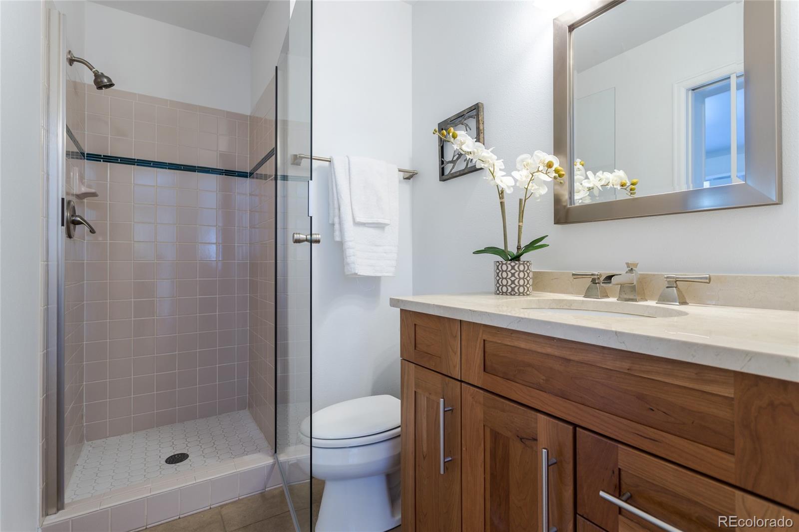5659 College Place Boulder, CO 80303 - Photo 17 of 27 a bathroom with a granite countertop sink toilet and shower
