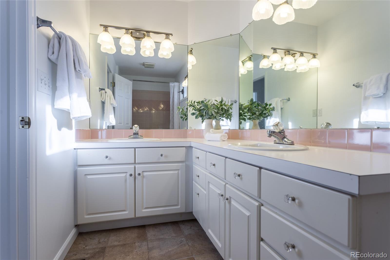 5659 College Place Boulder, CO 80303 - Photo 25 of 27 a bathroom with a double vanity sink and a mirror