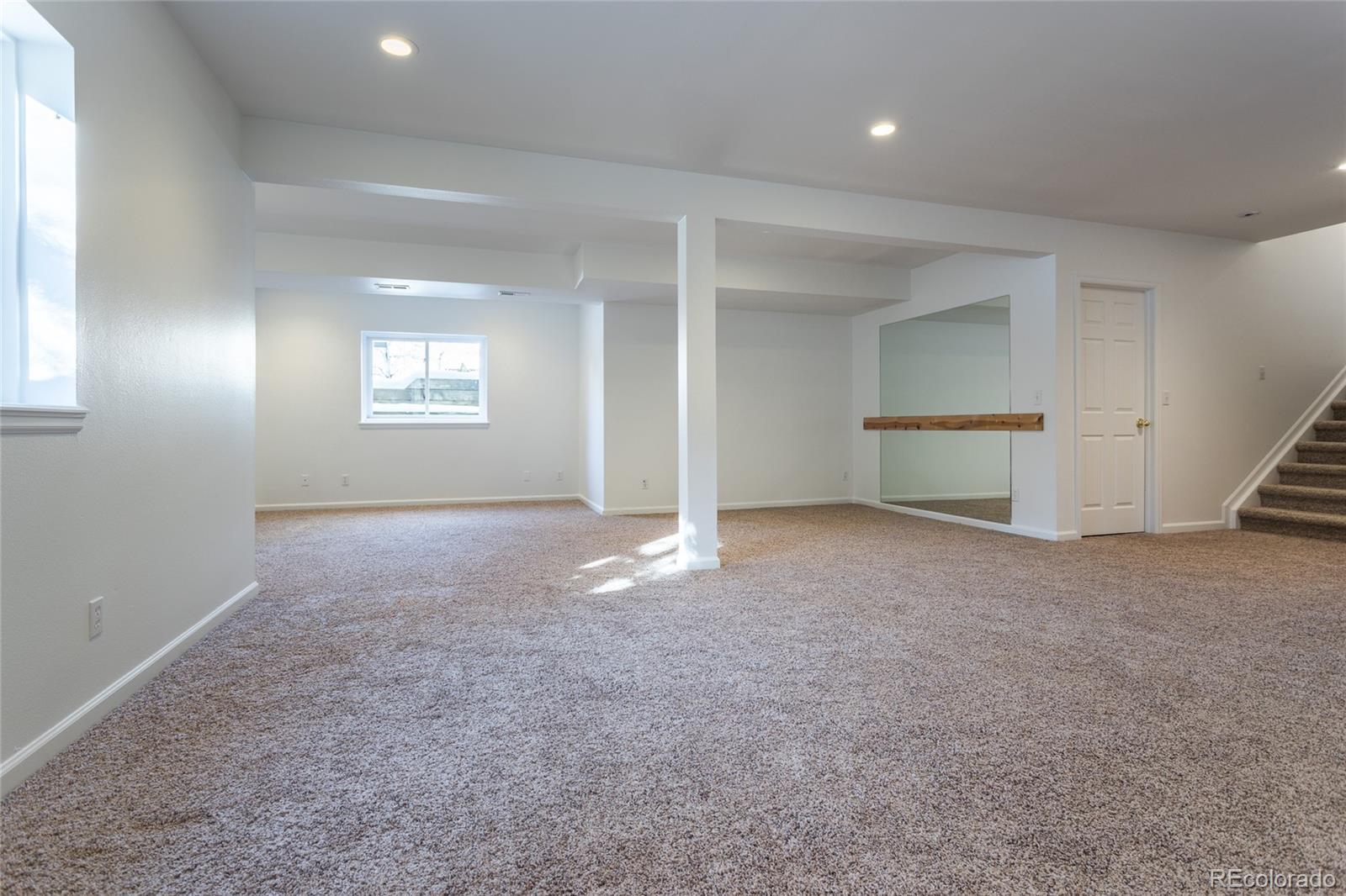 5659 College Place Boulder, CO 80303 - Photo 26 of 27 an empty room with windows and entrance to other room