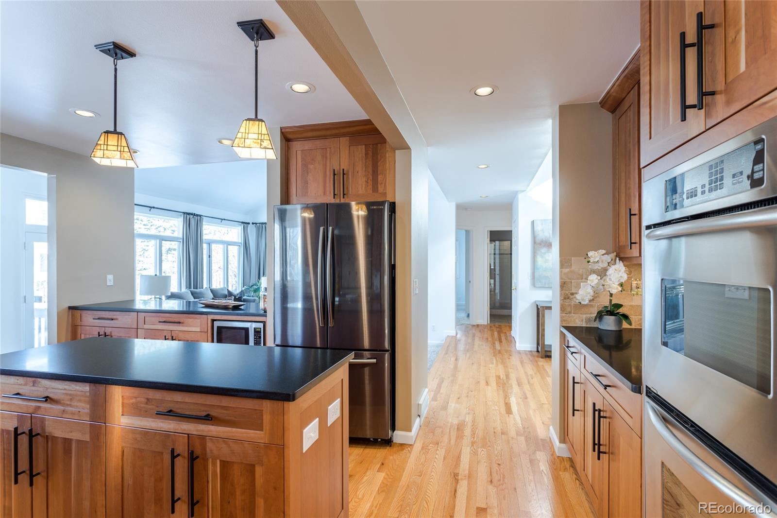 5659 College Place Boulder, CO 80303 - Photo 9 of 27 a kitchen with granite countertop a stove a sink a refrigerator and wooden floor