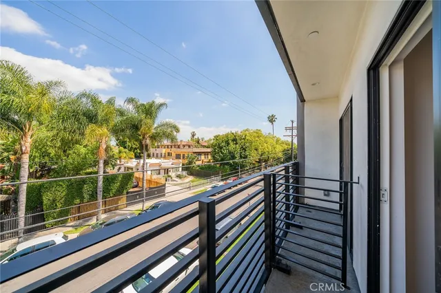 a view of balcony with wooden floor and fence