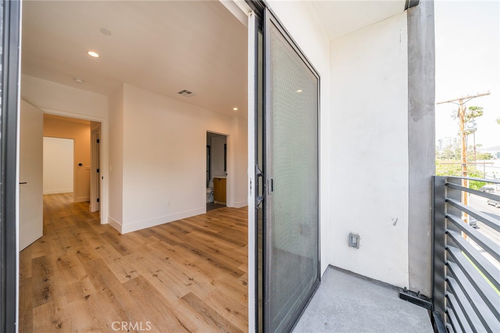6201 La Mirada Avenue, Unit 7 Los Angeles, CA 90038 - Photo 19 of 20 a view of hallway with wooden floor and a bathroom