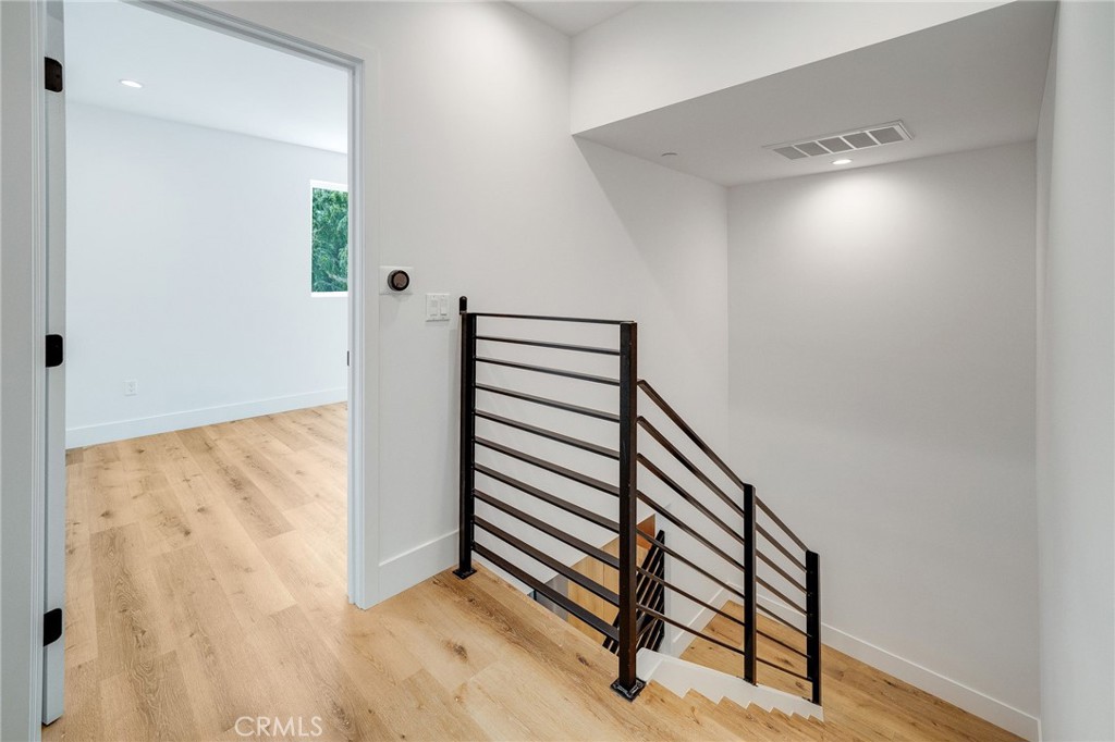 6201 La Mirada Avenue, Unit 7 Los Angeles, CA 90038 - Photo 9 of 20 a view of a room with wooden floor and white walls
