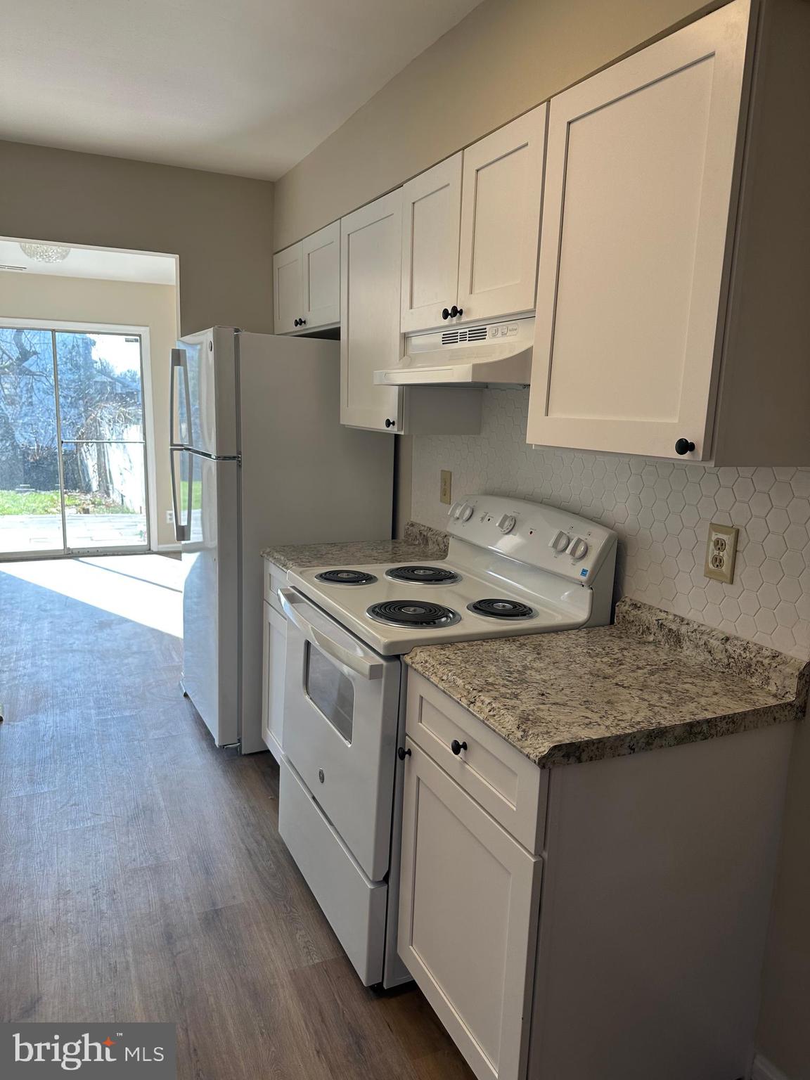 9637 Axehead Court Randallstown, MD 21133 - Photo 3 of 10 a kitchen with stainless steel appliances granite countertop a stove a sink and a refrigerator